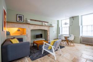 a living room with a couch and a table at Walcot Apartment in Bath