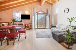 a living room with a table and a couch at Casa Sergio in Grosio