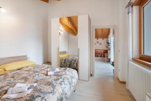 a bedroom with a bed and a mirror at Casa Sergio in Grosio