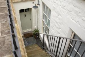 a stairway leading up to a white building with a door at Walcot Apartment in Bath