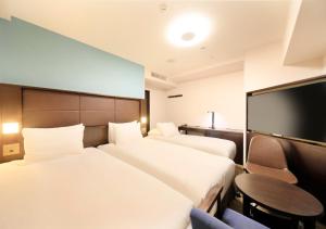 Postel nebo postele na pokoji v ubytování Richmond Hotel Namba Daikokucho