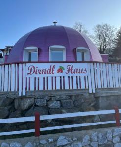 a round house with a fence in front of it at Dirndlhaus in Kirchberg an der Pielach