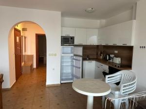 a kitchen with a table and chairs in a room at Fantastic Apartment in Sveti Vlas in Sveti Vlas