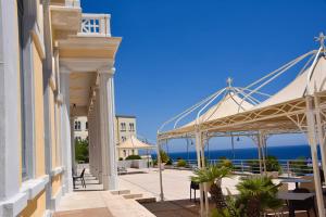 a view of the ocean from the balcony of a building at Albergo Palazzo in Santa Cesarea Terme