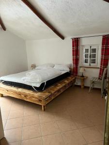 a bedroom with a large bed in a room at Camera matrimoniale con terrazza panoramica in Serina