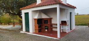 a small dog house with a white roof at Quinta da Abrunheira in Vimieiro