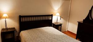 a bedroom with a bed and two lamps on two tables at Quinta da Abrunheira in Vimieiro +86 photos