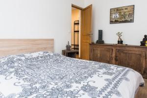 a bedroom with a bed with a black and white blanket at Charming one-of-a-kind apartment. in Saint-Ouen