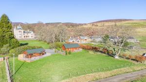 an aerial view of a house with a green yard at Pine Marten Lodge with Hot Tub in Cray