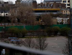 a parking lot with a basketball court in a city at Lovely 1-Bed Apartment in Hackney London in London