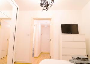 a bedroom with a mirror and a tv on a wall at Lovely 1-Bed Apartment in Hackney London in London