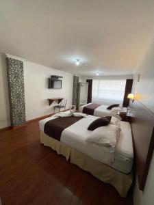 Postel nebo postele na pokoji v ubytování Gran Hotel Napoleón + 35 fotografií