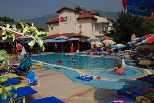 a pool at a resort with people in it at Tolay Hotel in Oludeniz
