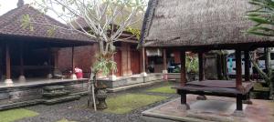a building with a tree in front of it at Villa Adhi Rajasa in Penebel