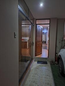 a hallway of a house with a glass door at Departamento amoblado en Arequipa, Cerro Colorado, Urbanización La Merced de Challapampa in Challapampa