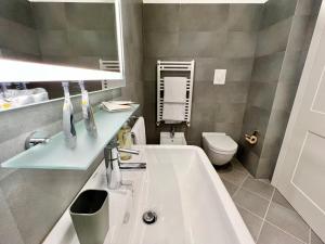a bathroom with a sink and a toilet at The Seven Suites in Genoa