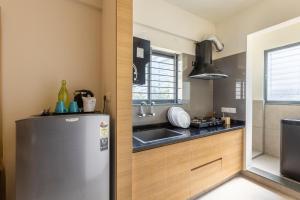 a kitchen with a stainless steel refrigerator and a sink at Iris Magnum - APart Hotel in Bangalore