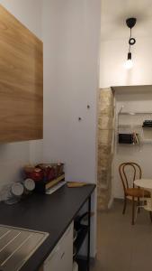 a kitchen with a counter top and a table and a dining room at Atelier B&B in Ascoli Piceno