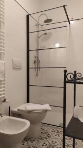 a bathroom with a shower and a toilet and a sink at Atelier B&B in Ascoli Piceno