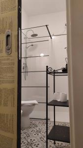 a bathroom with a toilet and a glass shower at Atelier B&B in Ascoli Piceno