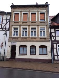 a large building with windows on a city street at Gästehaus-City in Helmstedt