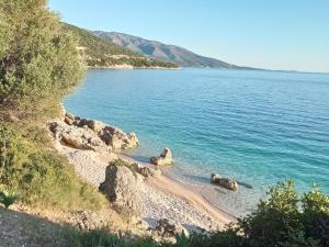 a beach on the side of a body of water at Asteri Apartments Mytikas 2-Bedroom Seaview Courtyard in Mitika