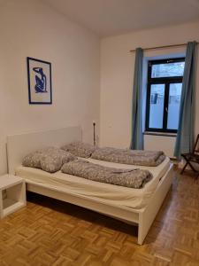 a bedroom with two beds in a room with a window at Cosy Apartment City Center in Leipzig