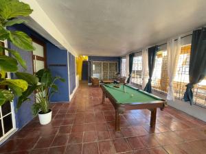 a room with a pool table in a room with windows at Casa Vibe San Juan Great for large groups in San Juan