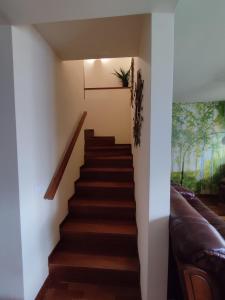 a staircase in a house with a couch at Casa adosada en Maçanet de Cabrenys in Maçanet de Cabrenys