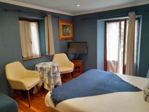 SopuertaにあるUrrezko Ametsaのベッドルーム1室(ベッド1台、椅子2脚、テレビ付)