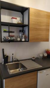 a kitchen with a sink and a counter top at Atelier B&B in Ascoli Piceno