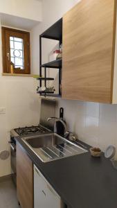 a kitchen with a sink and a stove at Atelier B&B in Ascoli Piceno