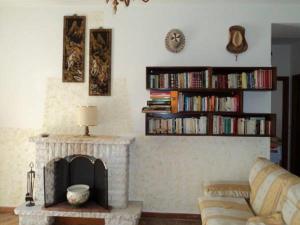 a living room with a fireplace and a couch at B&B Valente in Centola
