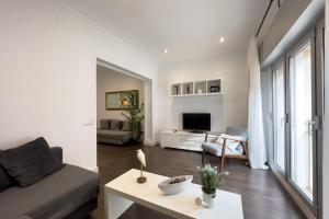 a living room with a couch and a table at Key Sagrada Família & Park Guell Apartment in Barcelona