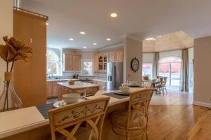 a kitchen with wooden cabinets and a table and chairs at Mountain Gem in Boone