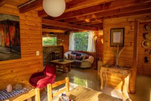una sala de estar de una cabaña de madera en BOG Budas del Bosque en Villa La Angostura