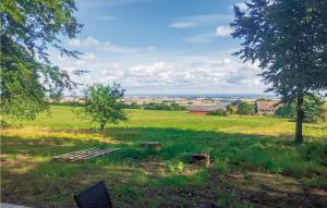 a field with a picnic table in the grass at Amazing Home In Kvidinge With 2 Bedrooms And Wifi in Kvidinge