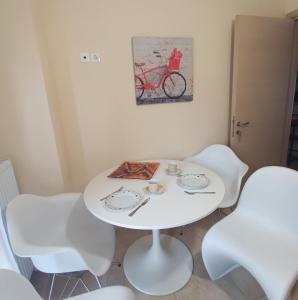 - une table et des chaises blanches dans la chambre dans l'établissement Modern Urban Flat, à Thessalonique