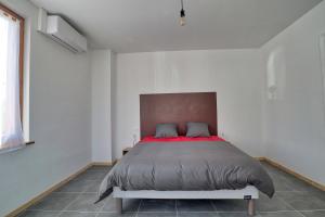 1 dormitorio con 1 cama grande con manta roja en Ab gite et spa, en Benfeld