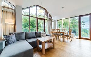 a living room with a couch and a table at Apartamenty Sun & Snow Resorts in Szklarska Poręba