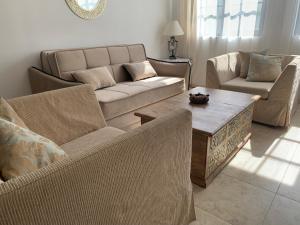 a living room with a couch and a coffee table at Beach Apartment in Obzor