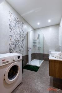 a washing machine in a bathroom with a shower at The Grove Valley Views Apartment w/ Communal Pool in Xagħra
