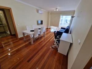 uma sala de estar com uma mesa de jantar e cadeiras em Green Park Ajuda Apartment no Funchal