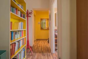 a hallway with bookshelves filled with books at Sunny Open Space in Pompei