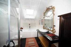 a bathroom with a sink and a tub and a mirror at Villa VERNEY in Albisola Superiore