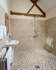 a bathroom with a sink and a shower at Groves Barn at Norton Grounds in Chipping Campden