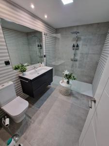 a bathroom with a tub and a sink and a toilet at Aurora in Avila +15 photos