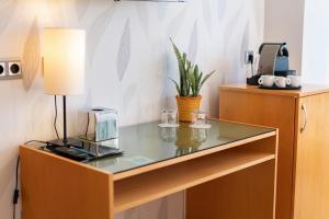 a glass table with a lamp and glasses on it at La Sort Boutique Hotel in Moraira