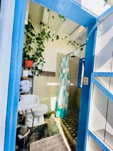 a bathroom with a toilet and a sink at La Bocana Beach House in Santa Maria Huatulco