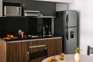 a kitchen with a sink and a refrigerator at Sonder Aria in Mexico City